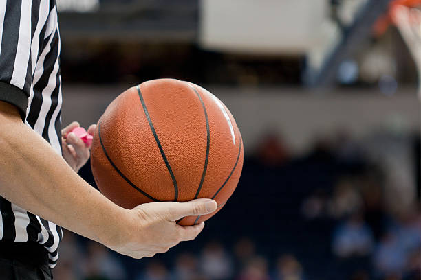 istock Basketball referee holds the ball during a time out. 149488407