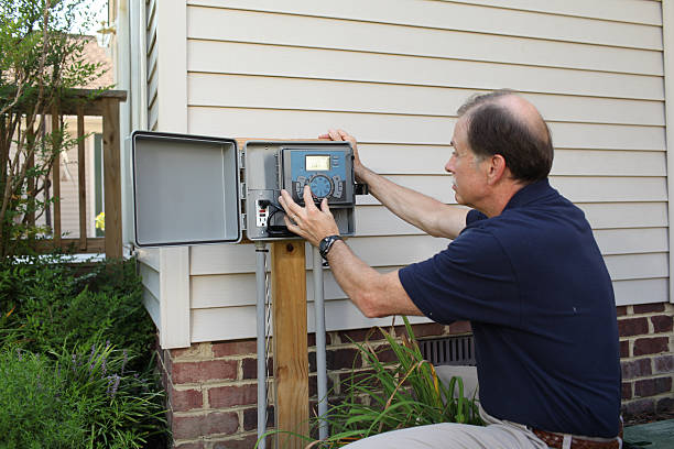 istock Mature adult male adjusts an irrigation system timer. 149488477