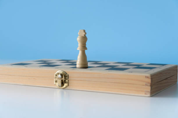istock Forgotten chess king. White chess king alone on a folded chessboard 1494886189