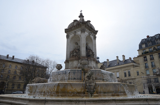 Paris, France - March 17, 2023: Fountain of Saint Sulpice located in the plaza of the same nameat Saint Germain quarter in Paris, France.