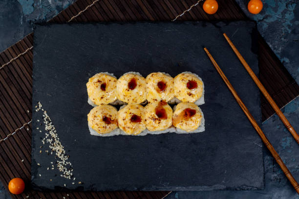 istock Asian cuisine, rolls and sushi on a dark background 1494888362