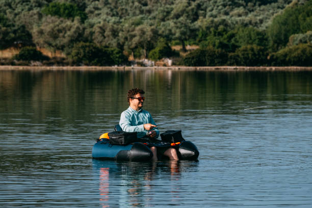 istock Man Fishing from Inflatable Boat 1494889398