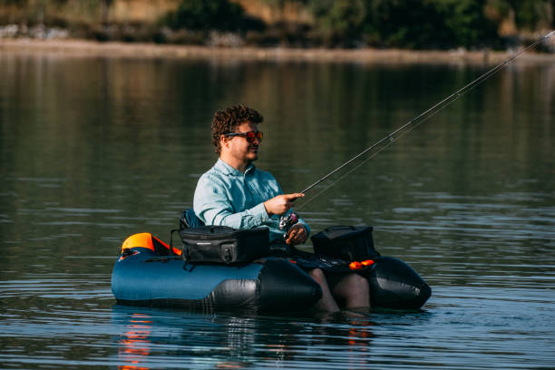 istock Man Fishing from Inflatable Boat 1494889411