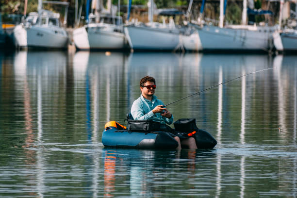 istock Man Fishing from Inflatable Boat 1494889975