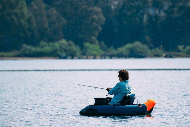 istock Man Fishing from Inflatable Boat 1494890053