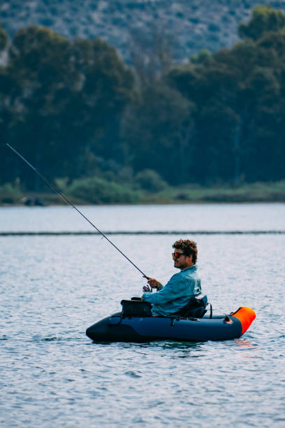 istock Man Fishing from Inflatable Boat 1494890137