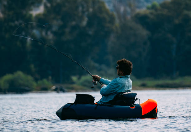 istock Man Fishing from Inflatable Boat 1494890138