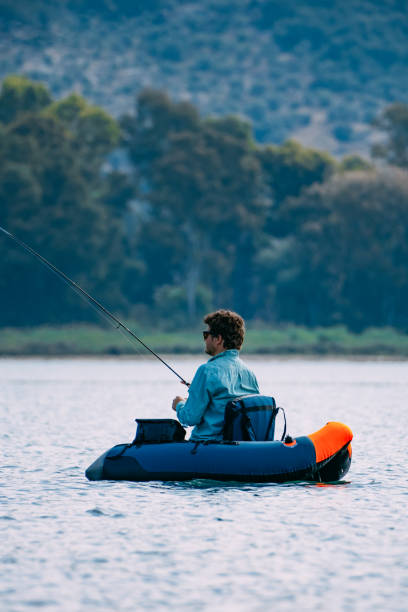 istock Man Fishing from Inflatable Boat 1494890139