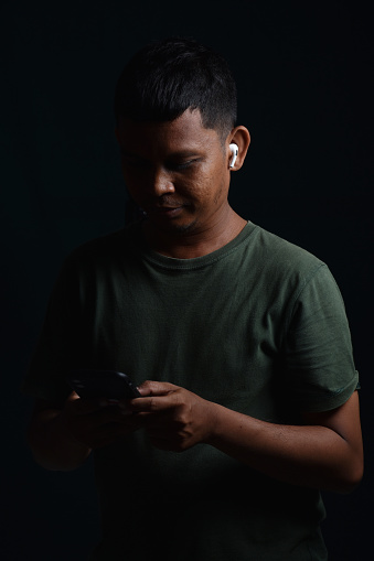 Asian man using earphones