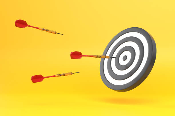 istock Darts fly at a target on a yellow background 1494890630