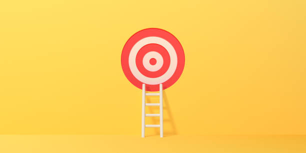 istock White ladder leads to a target on a yellow background 1494890718