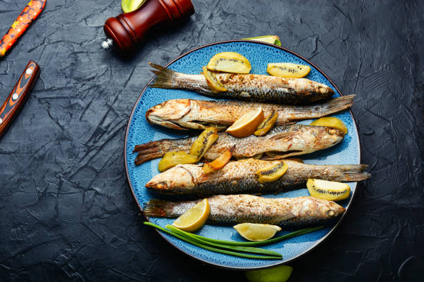 istock Fried whole fish with kiwi and lime. 1494891550