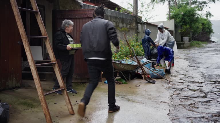 Family and friends taking a break while doing a yard cleanup in the rain