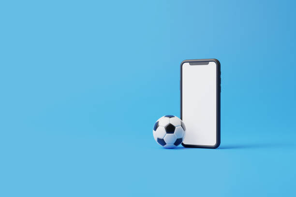 istock Mobile phone with a white screen and a soccer ball on a blue background with copy space 1494894512