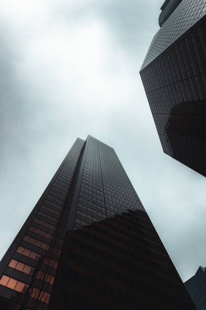 istock two tall skyscrapers towering in the sky over another building 1494897741