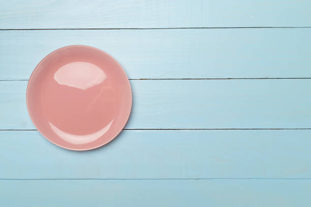 istock Empty round plate on wooden background, top view 1494899969