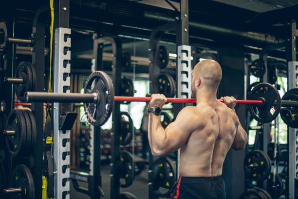 istock Muscular bodybuilder exercising with barbell 1494901612