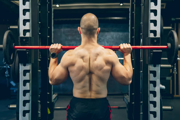 istock Muscular bodybuilder exercising with barbell 1494902892