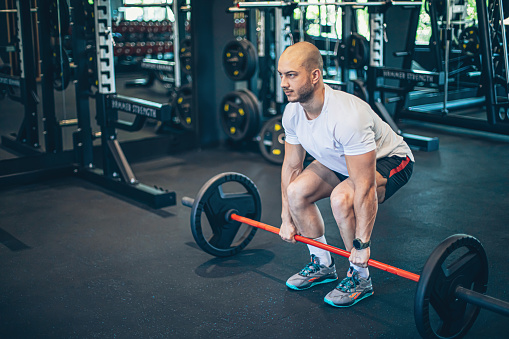 Strong man doing deadlift training in gym