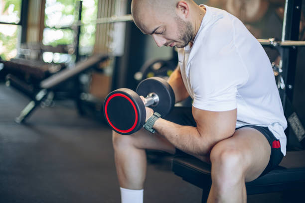 istock Muscular bodybuilder exercising with barbell 1494903686