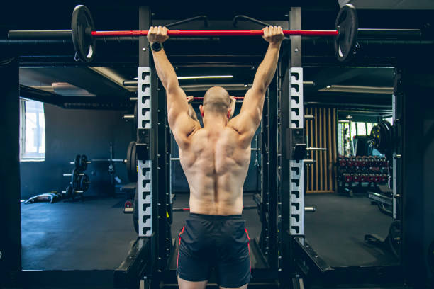 istock Muscular bodybuilder exercising with barbell 1494903890