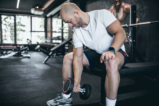 istock Muscular bodybuilder exercising with barbell 1494904275