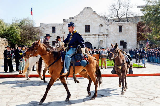 Reenactment of Gen. Twigg's surrender at the Alamo San Antonio, Texas, USA, February 13, 2010: Co. "K", 6th Texas Infantry Regiment reenacts General Twiggs' surrender of all forts in Texas to Colonel Ben McCulluch and his secessionist Texas militia on February 16, 1861. The soldiers and their individual weapons were permitted to leave. battle reenactment stock pictures, royalty-free photos & images