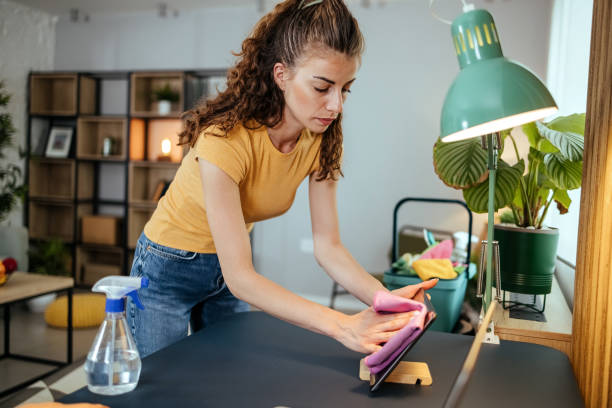 Woman cleaning table stock photo