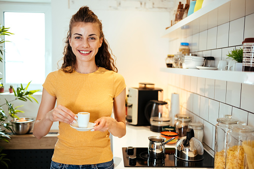 Portrait of a woman enjoying coffee in the kitchen