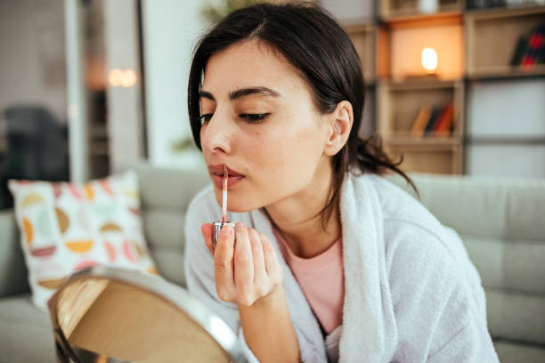 istock Beautiful woman paints lips with lipstick 1494909485