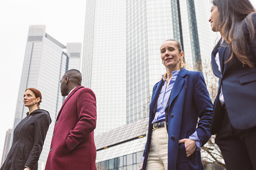 Stylish Business Professionals Engage in Friendly Conversation while Gearing up for a Meeting in Frankfurt's Business District.
Fun fact: Frankfurt is home to the Frankfurt Stock Exchange, where billions of euros' worth of securities are traded daily, making it one of the world's leading stock exchanges.