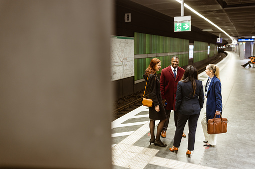 Business people waiting a train in a subway platform after work. Frankfurt, Germany