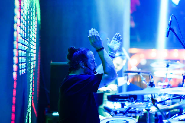The drummer plays live music on stage