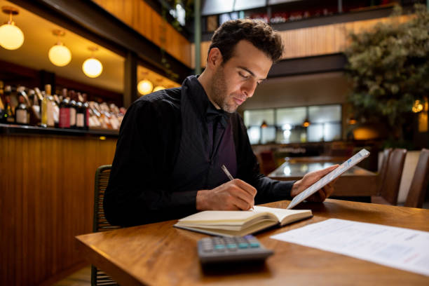 Successful business owner bookkeeping at a restaurant