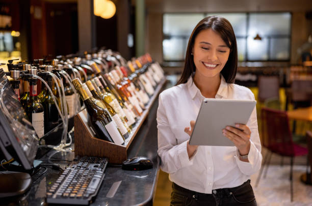 istock Happy restaurant hostess holding a tablet and smiling 1494912691