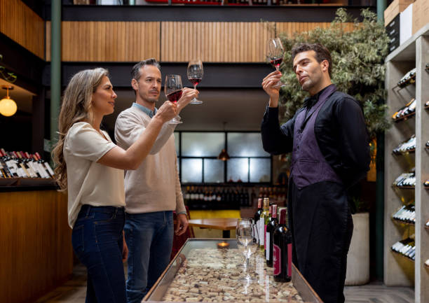 istock Sommelier explaining details at a wine tasting with a couple 1494912790