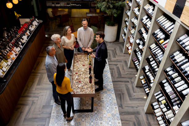 istock Sommelier talking to a group of people at a wine tasting 1494912808