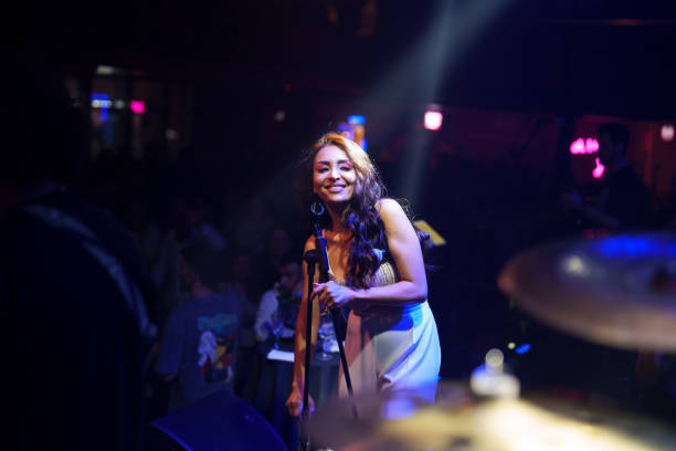 istock Female singer on stage with spotlight 1494913016