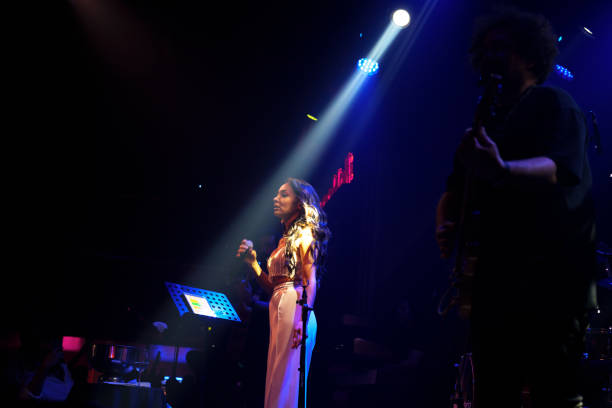 istock Female singer on stage with spotlight 1494913017