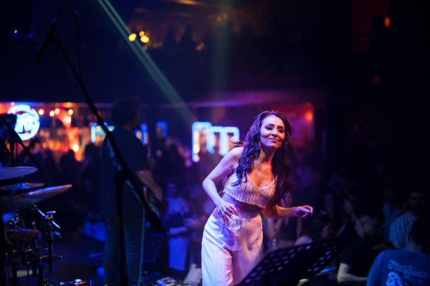 istock Female singer on stage with spotlight 1494913046