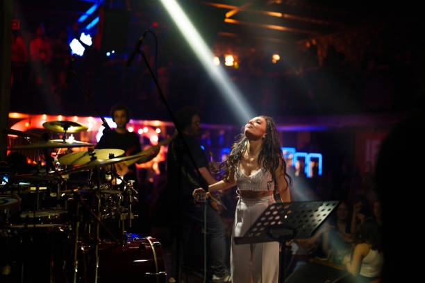 istock Female singer on stage with spotlight 1494913089