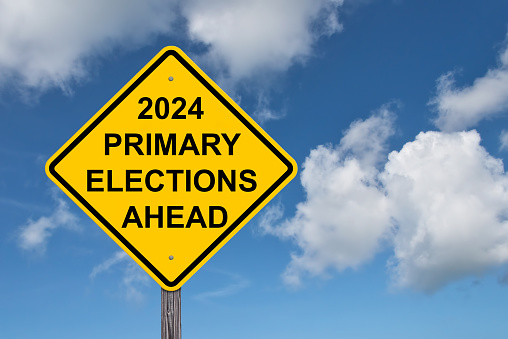 2024 Primary Elections Ahead Caution Sign - Blue Sky Background