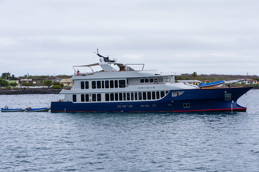 Puerto Moreno, Galapagos, Ecuador - August 21, 2022: The luxury yacht Origin, owned by Relais and Chateaux, anchored in Puerto Moreno in the Galapagos Island of Ecuador.
