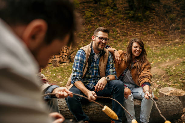 istock Multi-ethnic hipster friends on summer holidays having fun roasting corn 1494918634