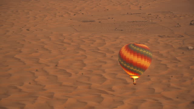 Aerial view of hot air balloon flying on desert in Dubai, U.A.E.