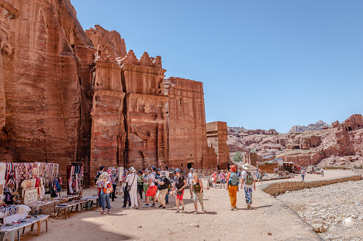Petra, Jordan - April 16 2023: View of the Street of Facades, the row of monumental Nabataean tombs  carved in the southern cliff face that lies past the Treasury and adjacent to the outer Siq.