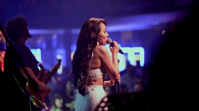 Musician singing with microphone  on stage show