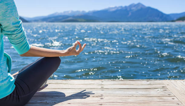 istock Woman practicing yoga by the sea. 1494925685