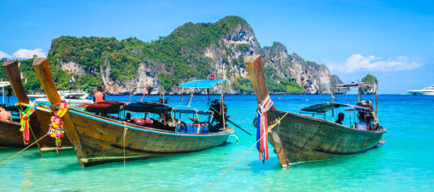 istock Traditional longtail boats near beautiful tropical island Ko Phi Phi, Thailand 1494928400