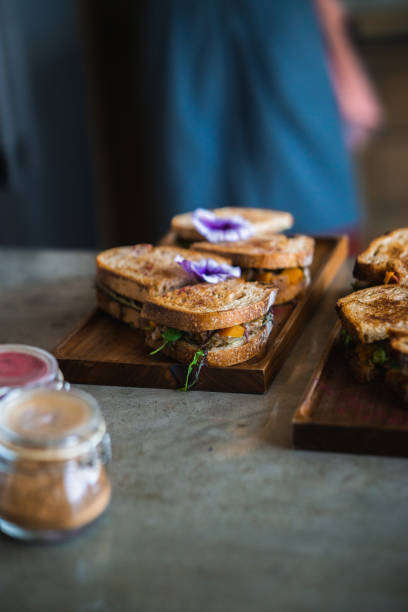 istock Two vegan sandwiches prepared on a plate on a marble countertop. 1494936323